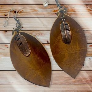3.5” handmade leaf shaped leather earring with feather charm.